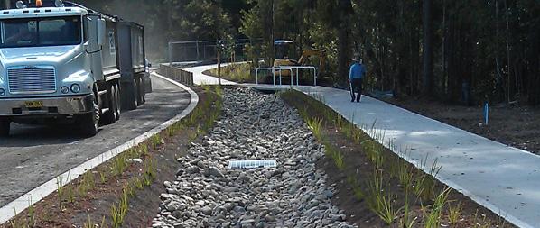 Timbertown Estate road and pathway Timbertown Estate showing road in use and person on pathway adjacent to bushland